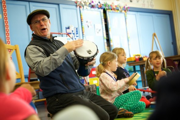 Teacher and students playing drums