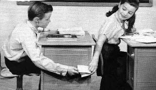 Black and white old time photo showing kids passing notes in class