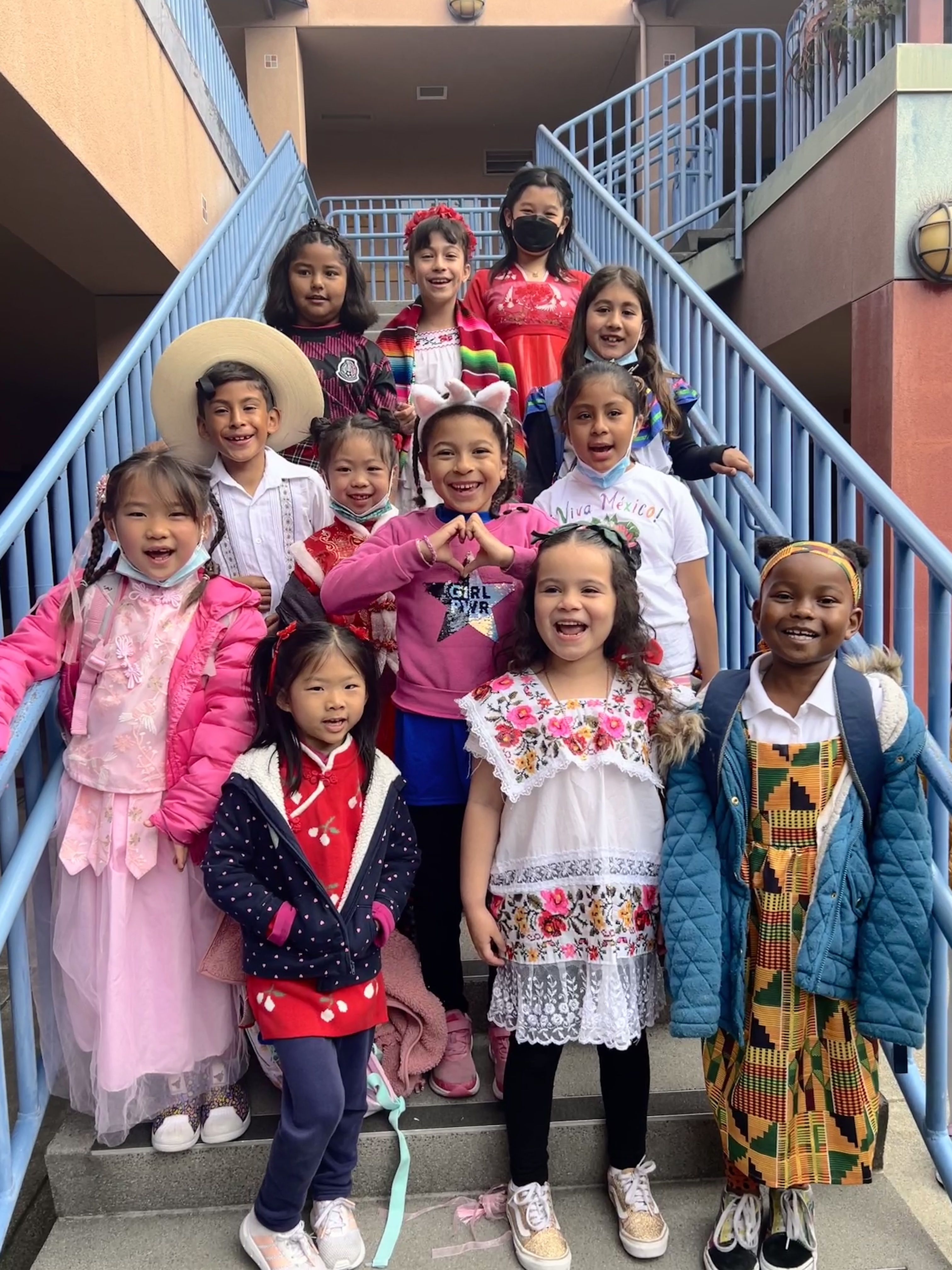 Happy diverse students on blue staircase