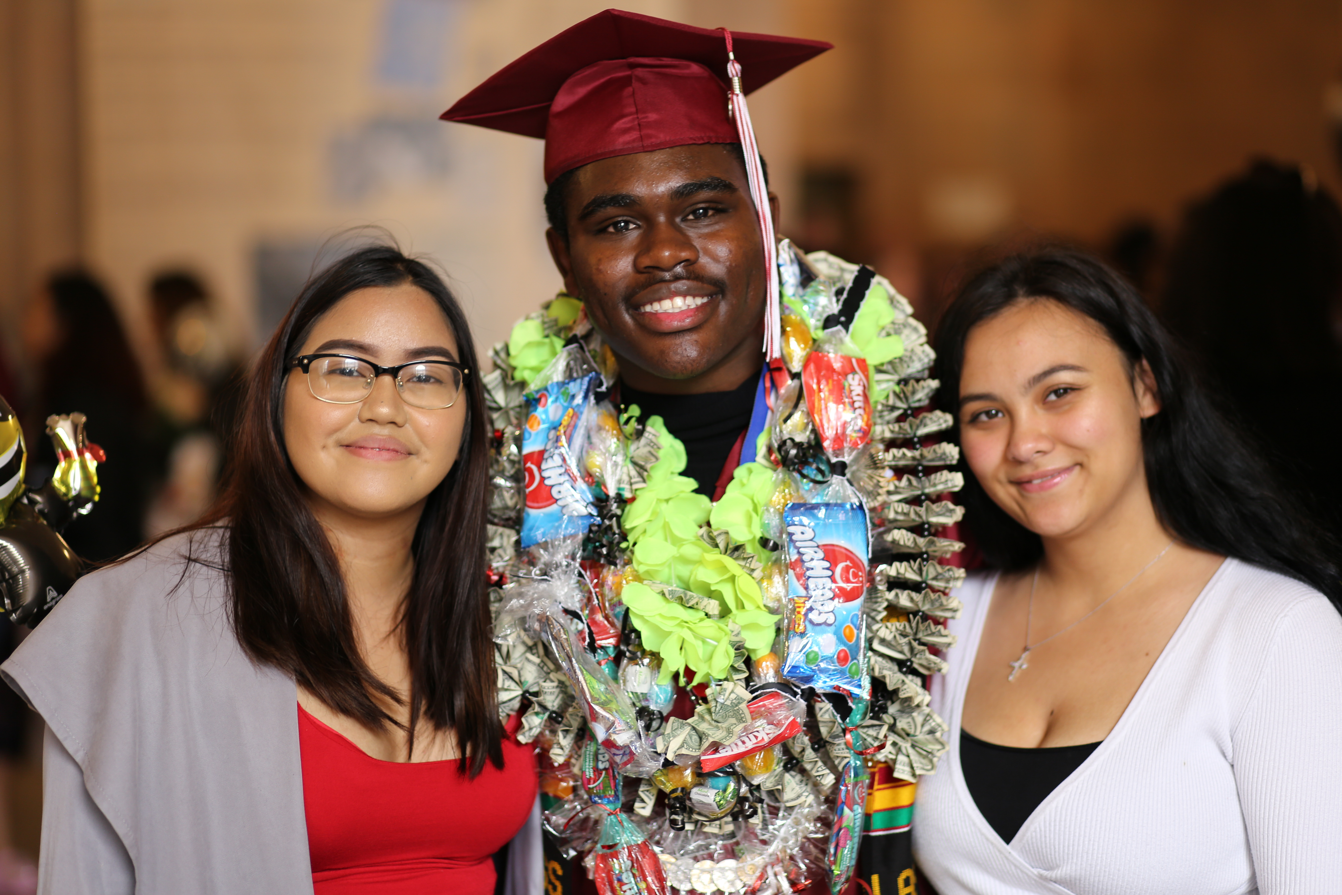 A graduating senior with two friends