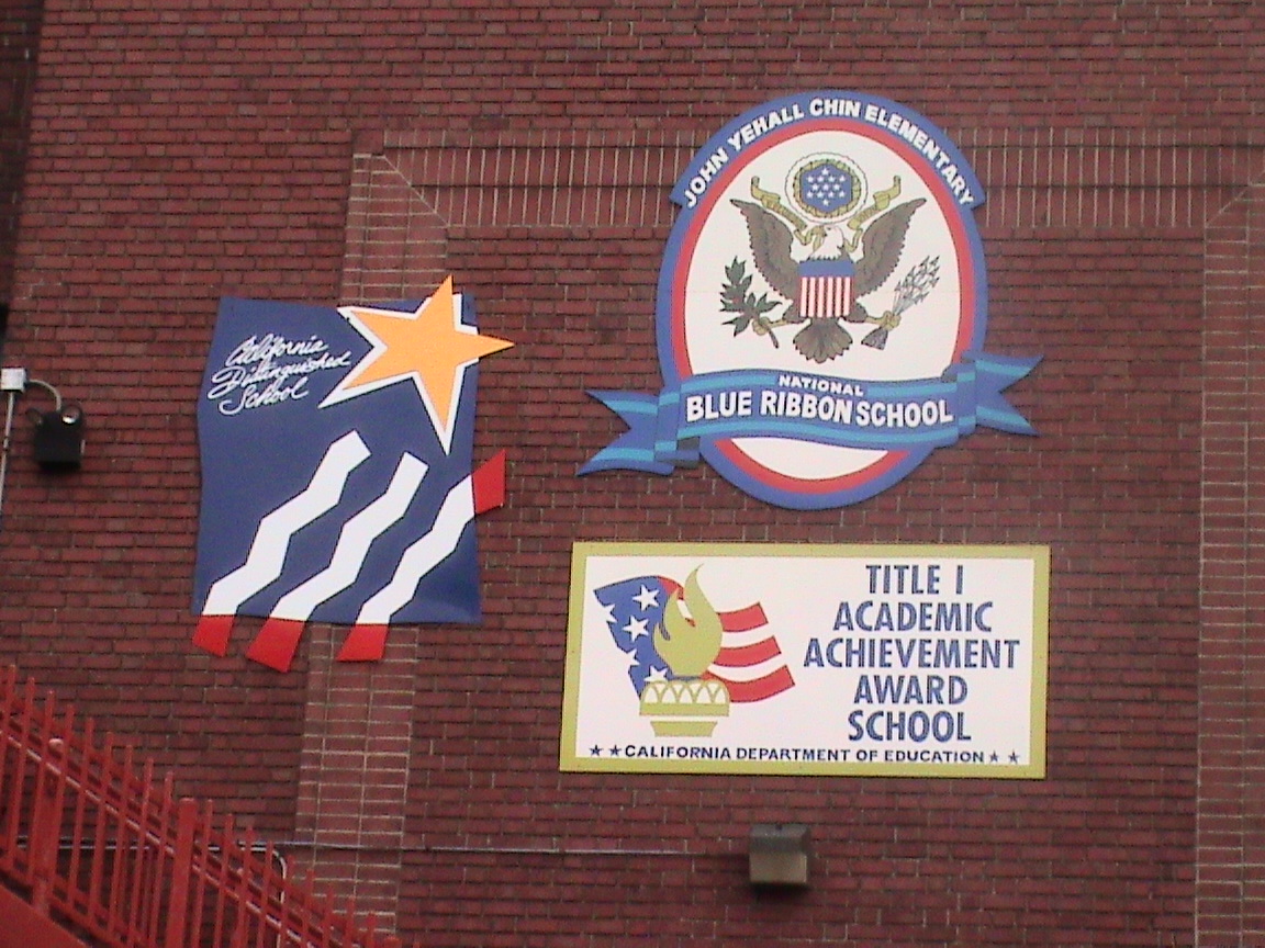 Blue Ribbon and Title I Academic Achievement awards on John Yehall Chin Elementary School building