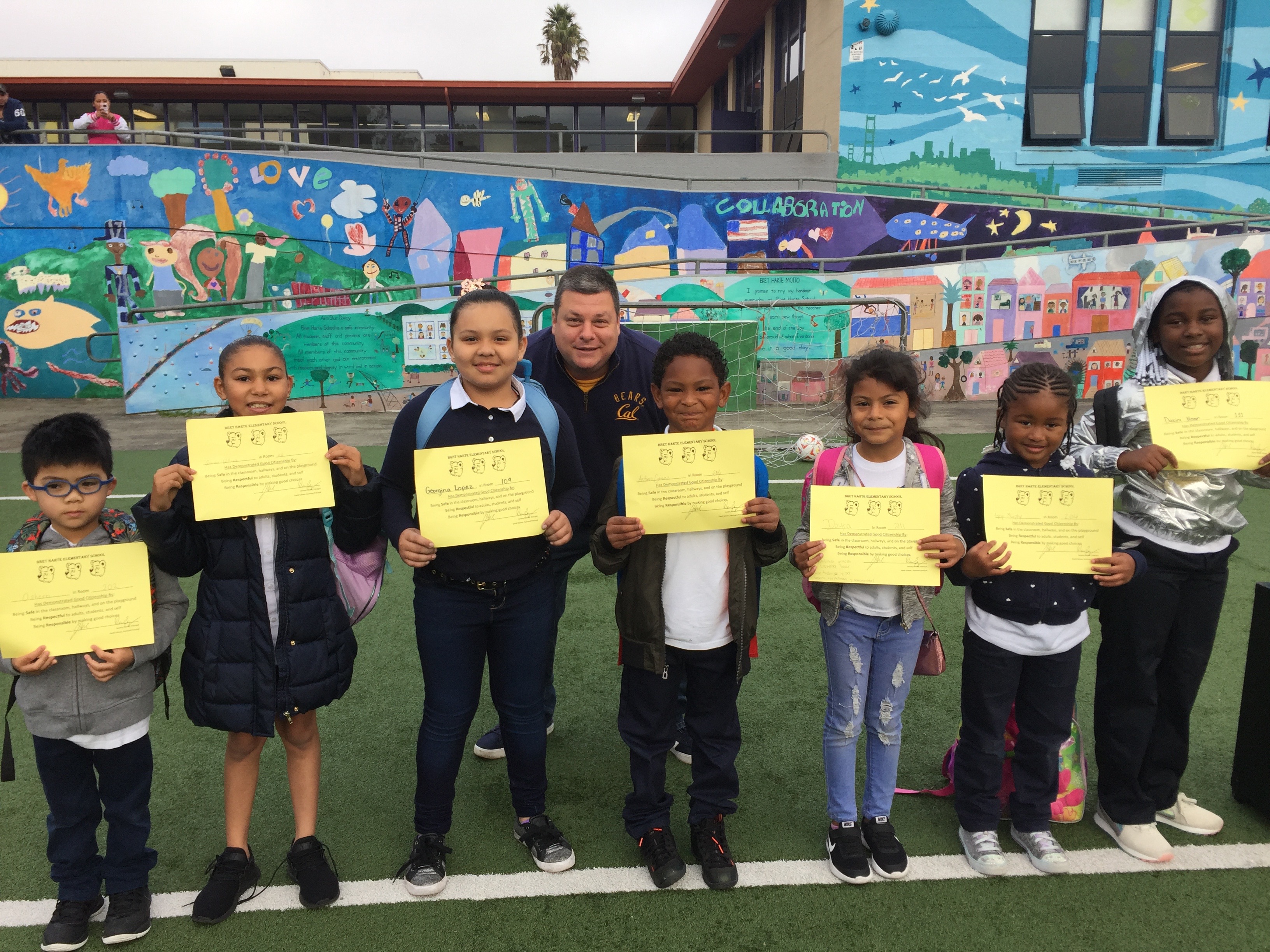 Row of elementary students receiving an award.
