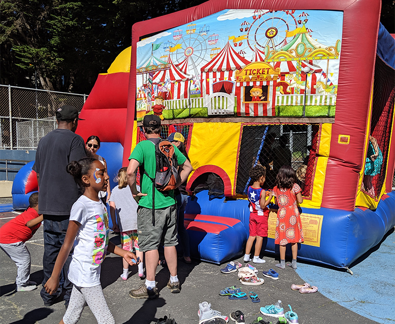Kids lining up for the jumpy house at the Rosa Parks Community BBQ