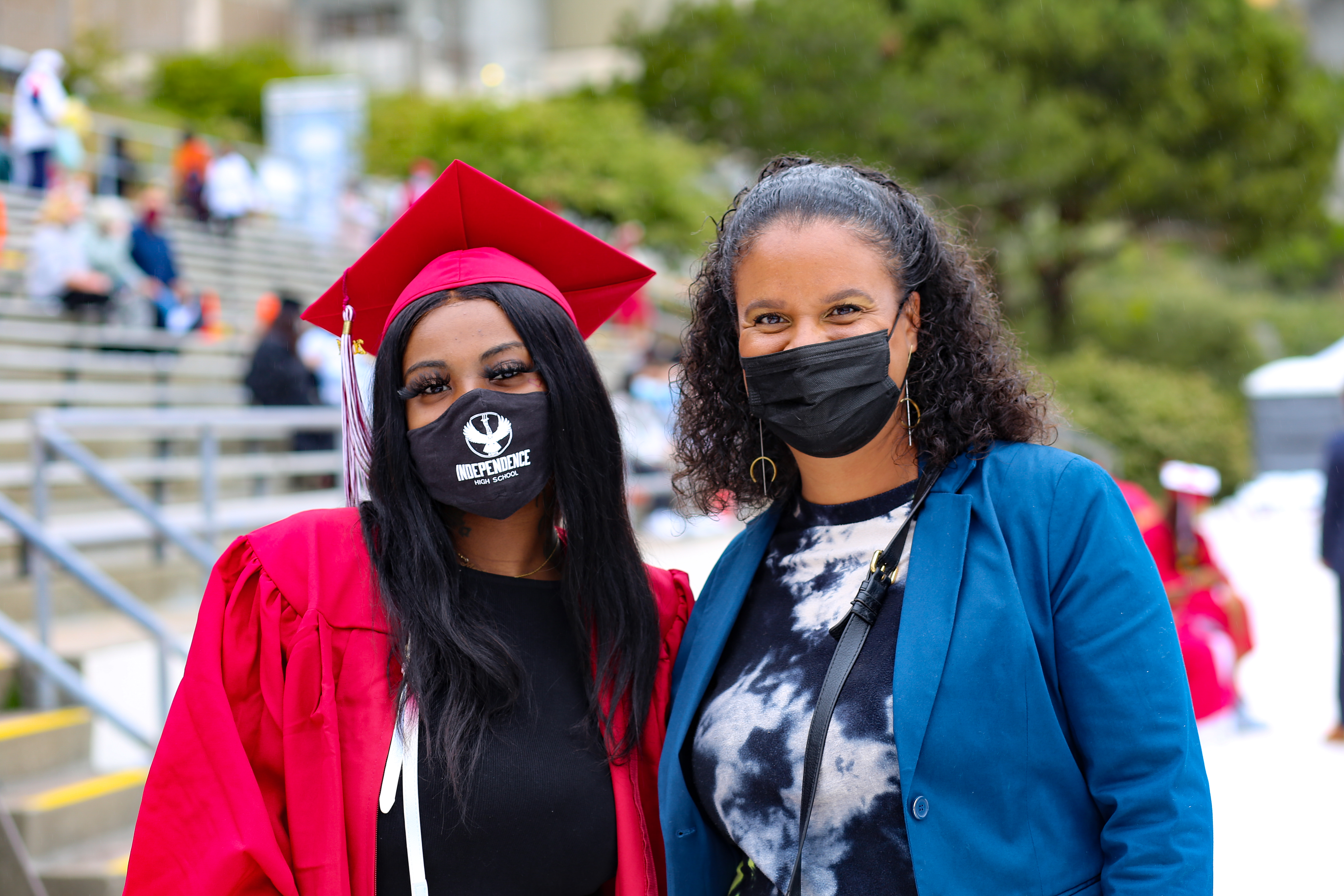 a student poses with a teacher at the 2021 graduation ceremony