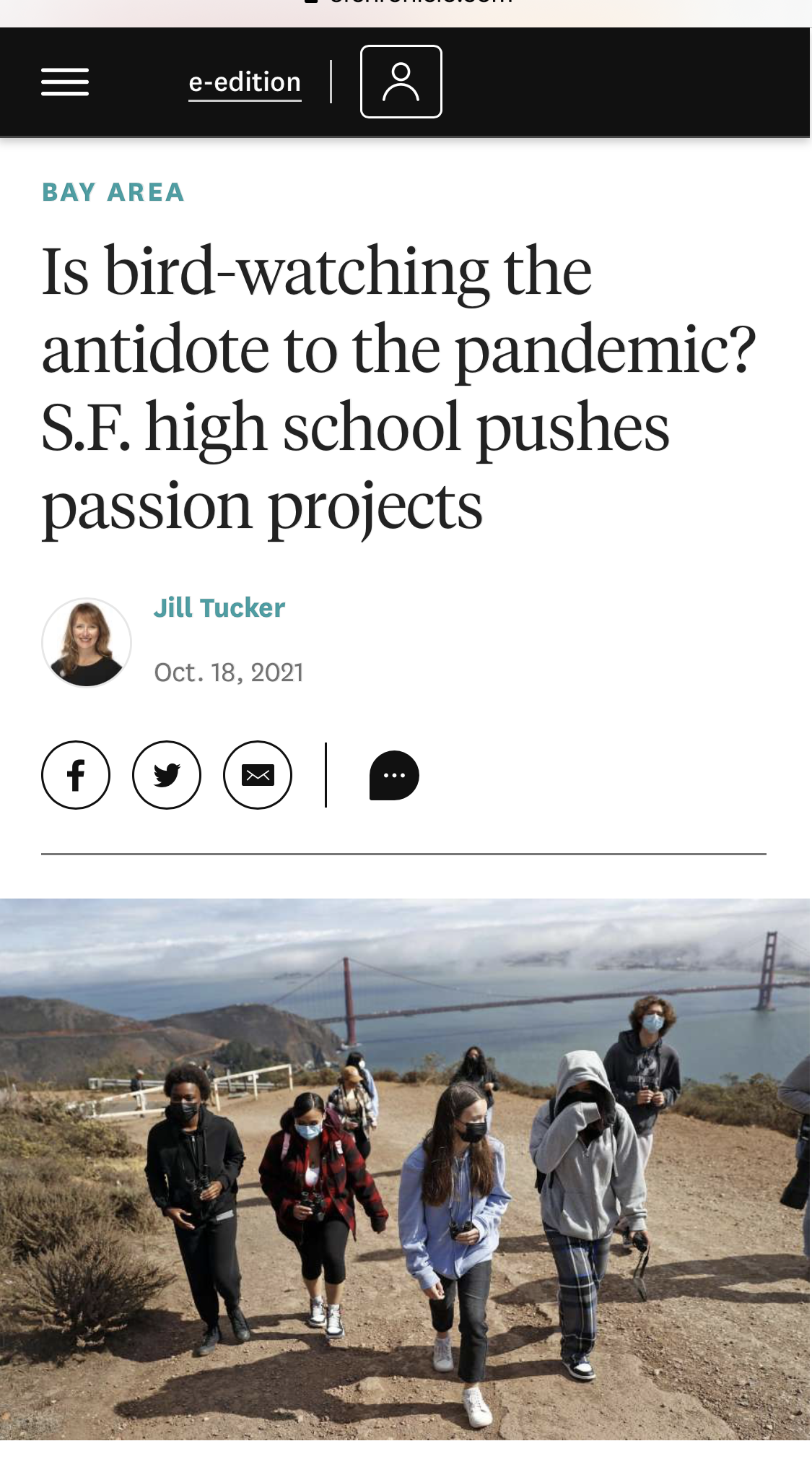 Photo of students walking up a mountain with golden gate bridge behind them
