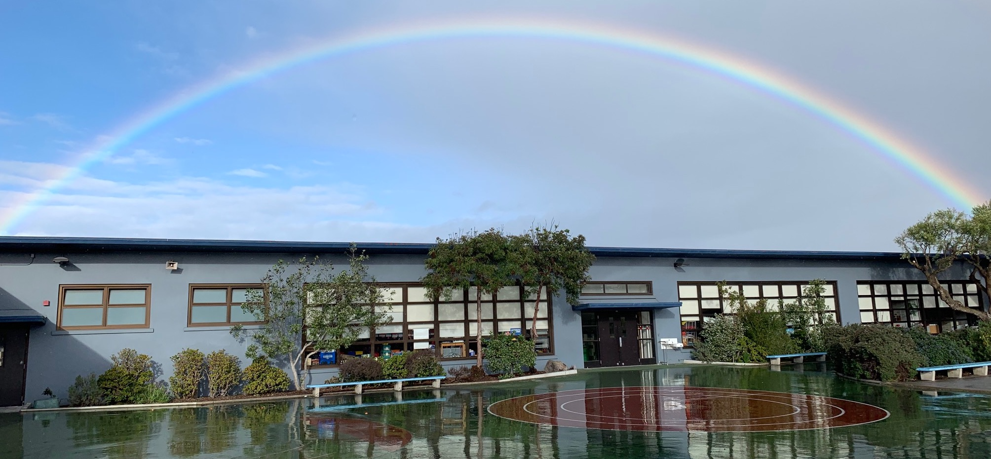 Sunset Elementary after rain, with a rainbow overhead