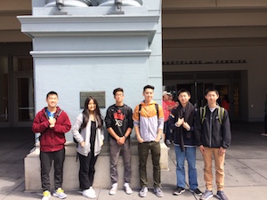 Students standing in front of a statue