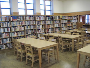 table surrounded by shelves full of books