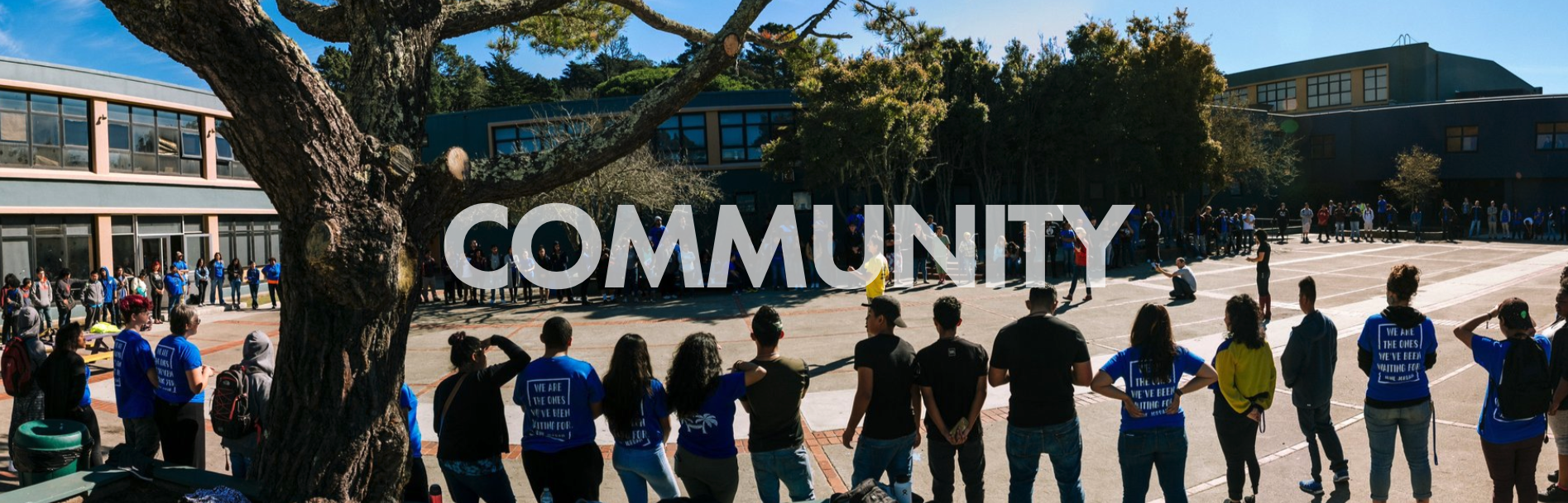 students and staff standing in a circle outside