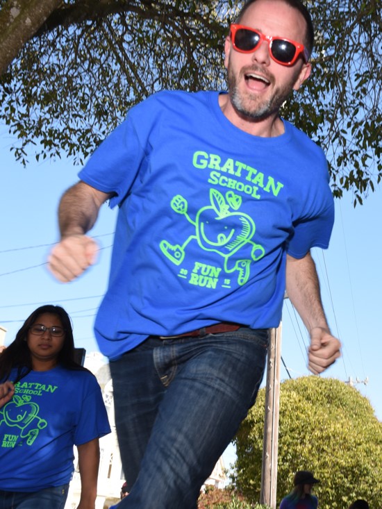 Principal jogging at an outdoor school fitness event