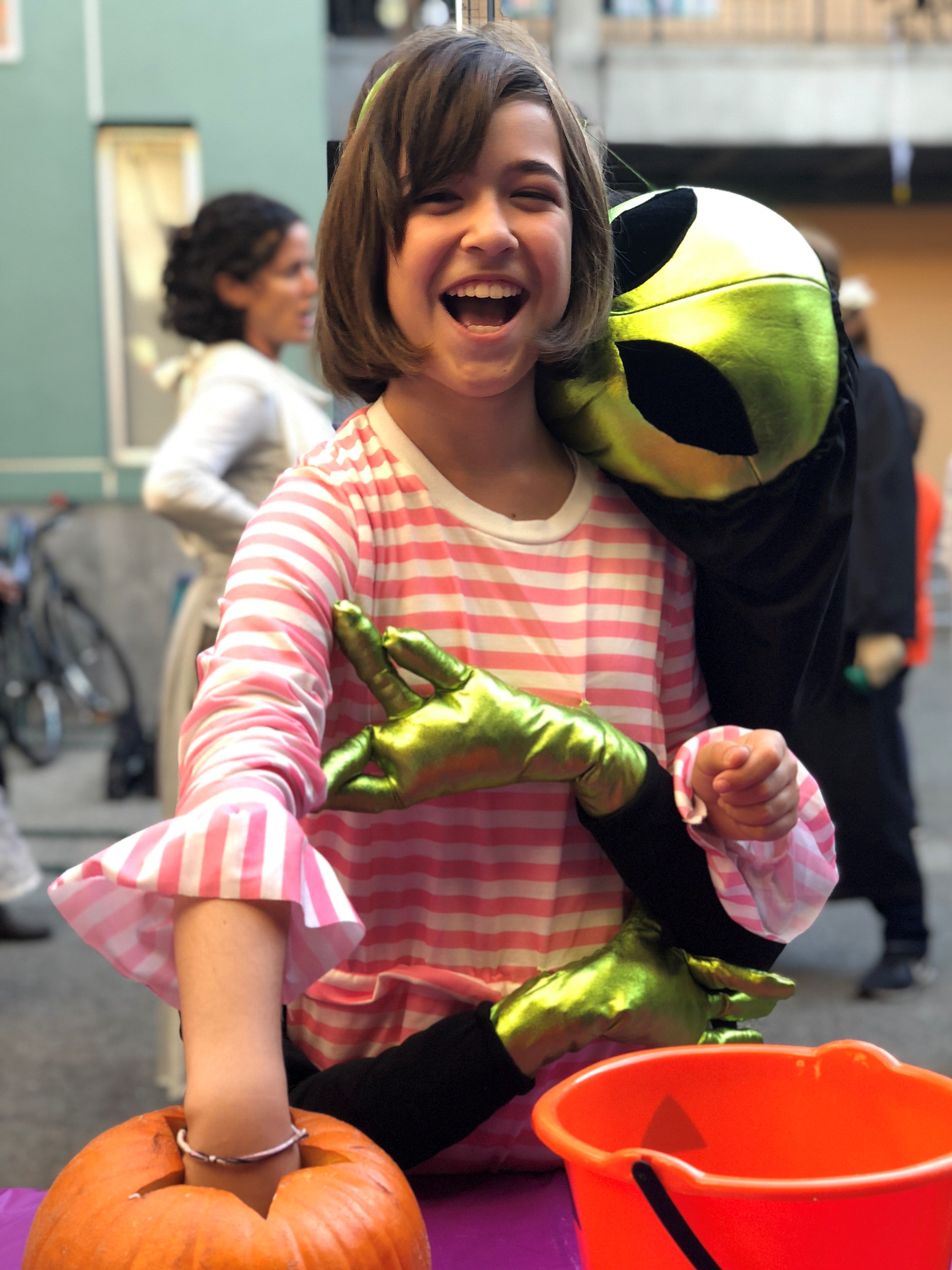 Girl dressed up in an alien costume at a school Halloween event