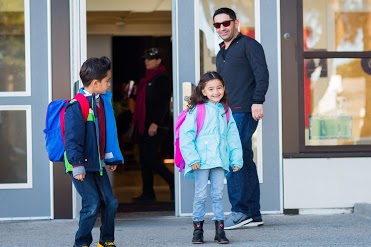 Family leaving the school building in the afternoon