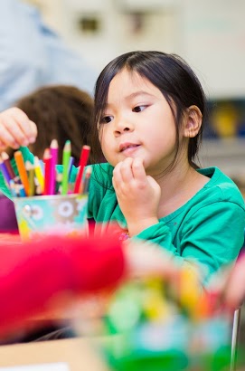 Student choosing a marker from a cup