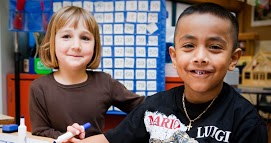 Two students side by side at a table