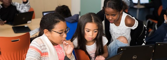 Group of students working together on a laptop