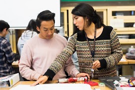 Teacher helping a student with class work