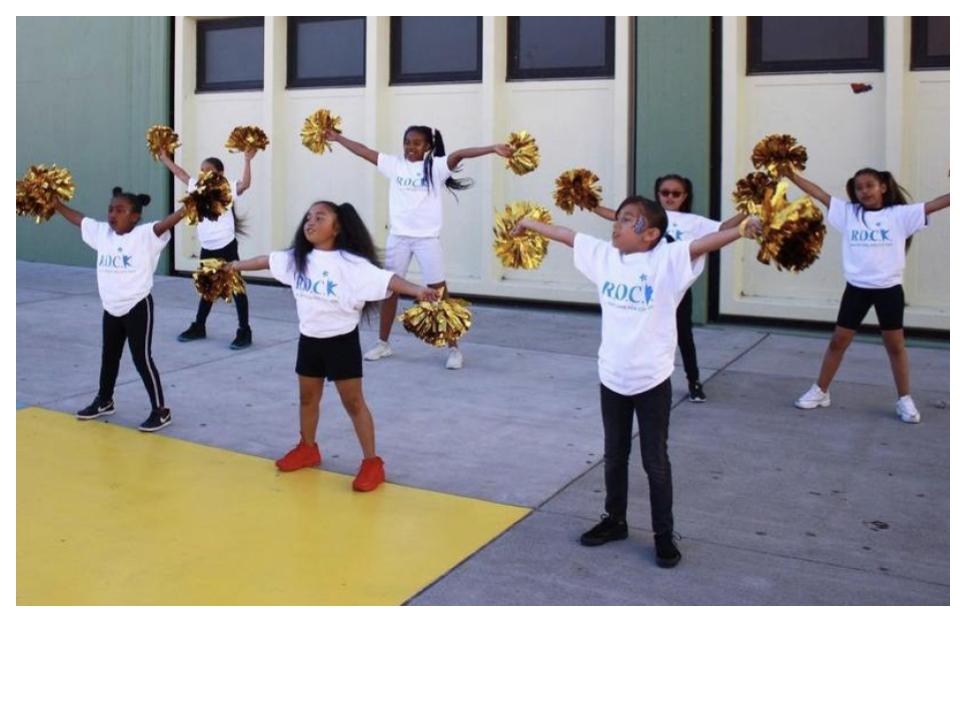 children with pompoms cheering