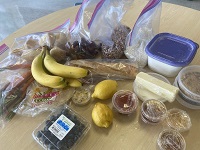 Bananas, berries, condiments, and packaged food as part of a take-home meal kit for Marshall High School's Career Pathways program