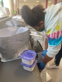 A student puts together a meal kit at Marshall High School as part of the Career Pathways program