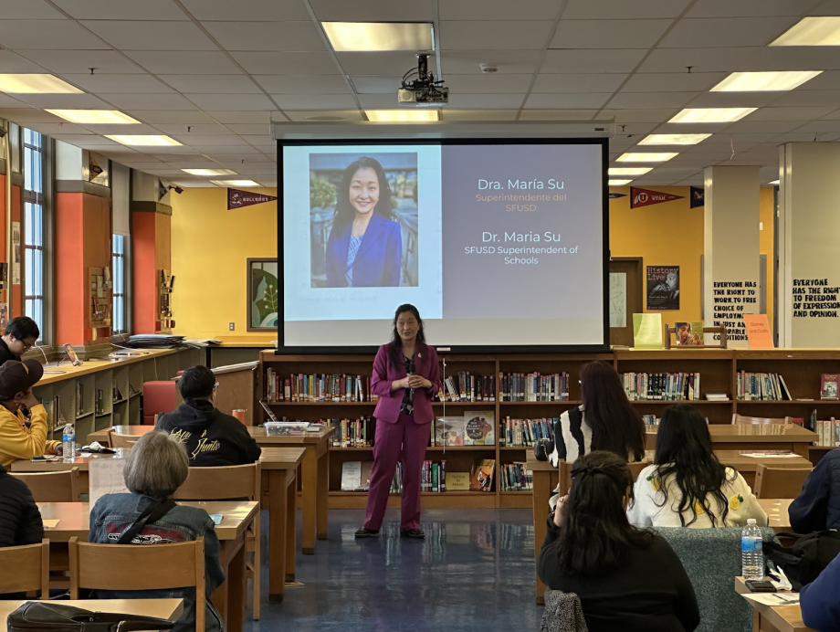 Dr. Su speaking in a library