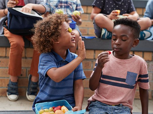 Two children eating and playing