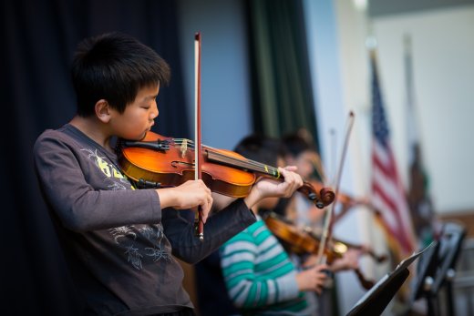 Stock photo of students playing the violin