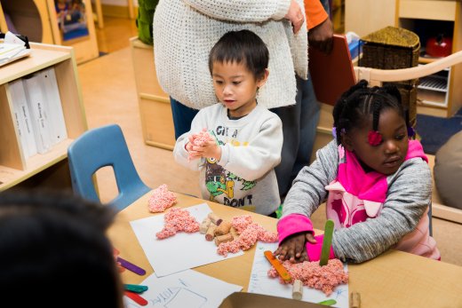 children using playdough at the table