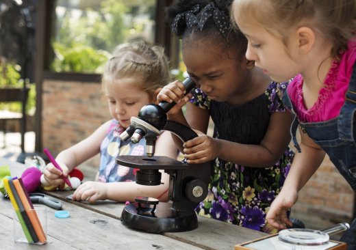 children looking at a microscope