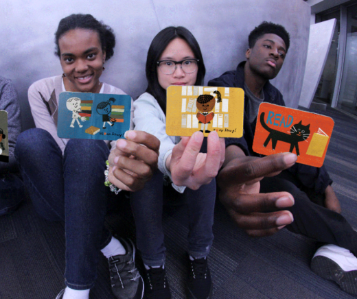 3 students holding up their public library card