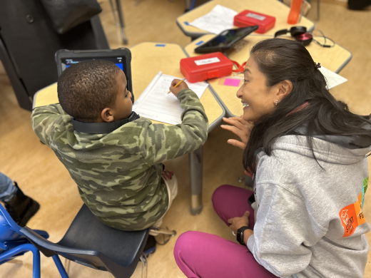 Dr. Maria Su speaking with an elementary school student at Carver Elementary