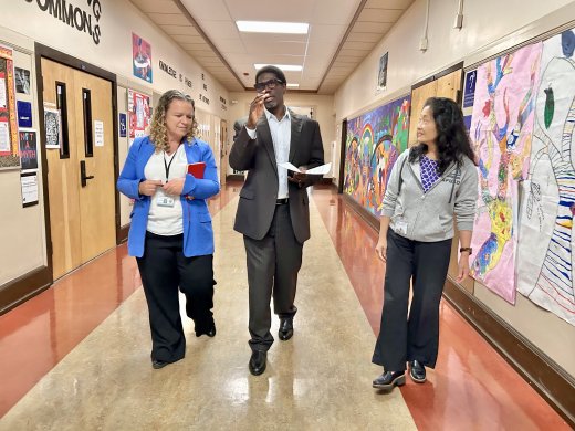 Superintendent Su walking in school hallway