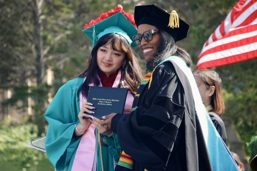 Principal gives diploma to student