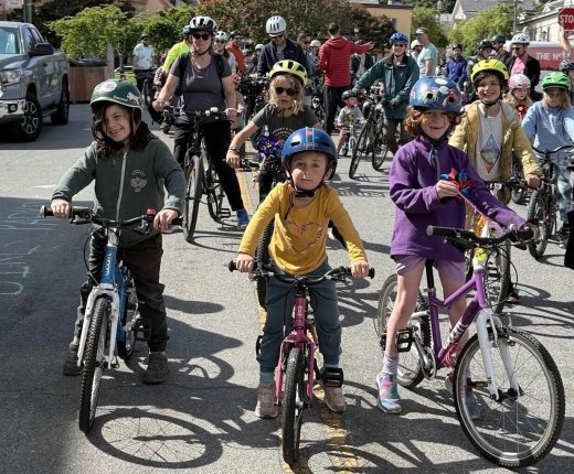 students on bikes with their helmets on posing for picture