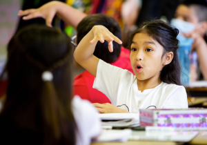 3rd grade student engaged in discussion with table partner