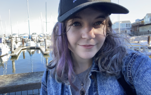 Nicole selfie in front of sailboats on a doc