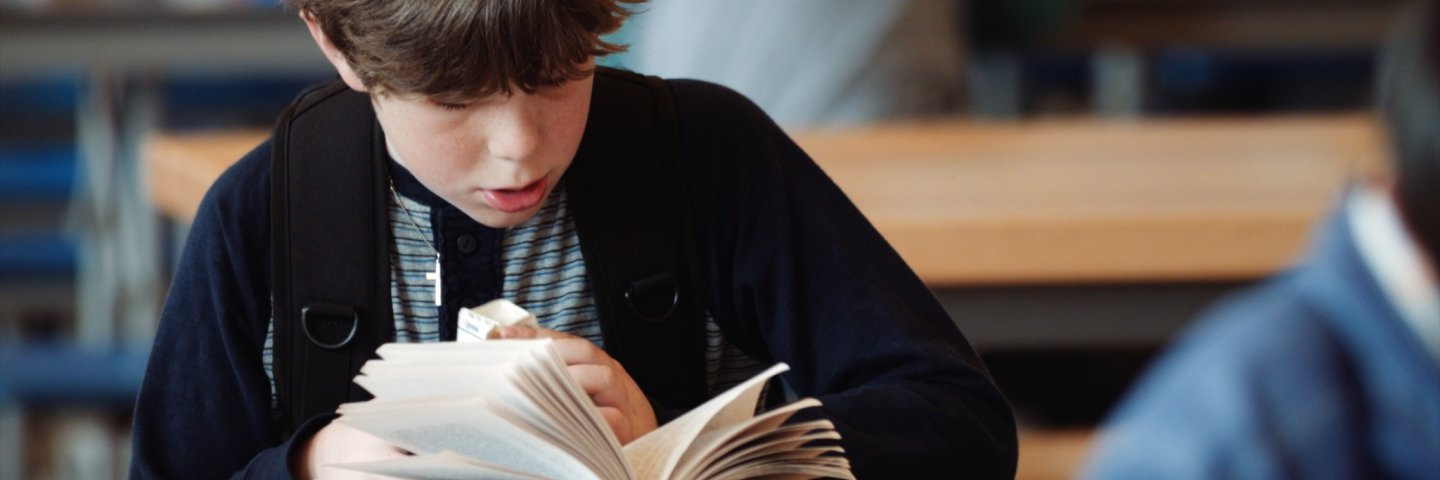 a boy reading a book