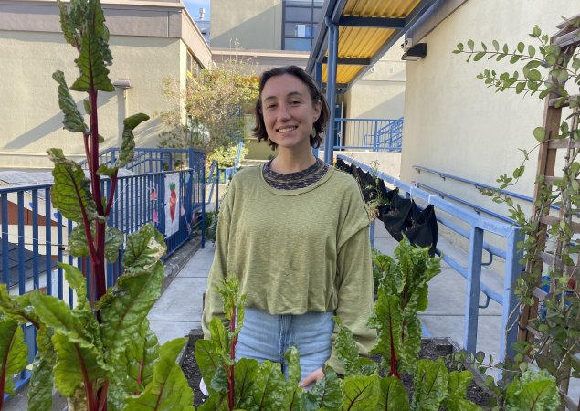 Sarah Bayer, a garden teacher at George Peabody Elementary School, stands in the school garden