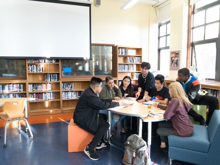 high school students sitting together in library