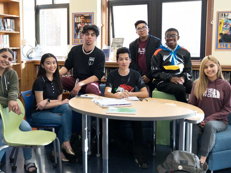 Balboa High School students smiling and staring at a camera