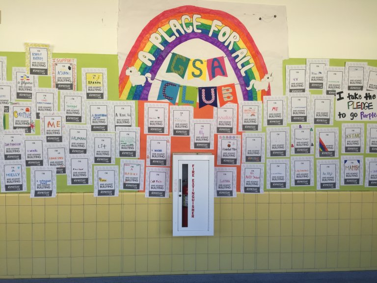 School wall covered in anti-bullying pledges by Hoover students