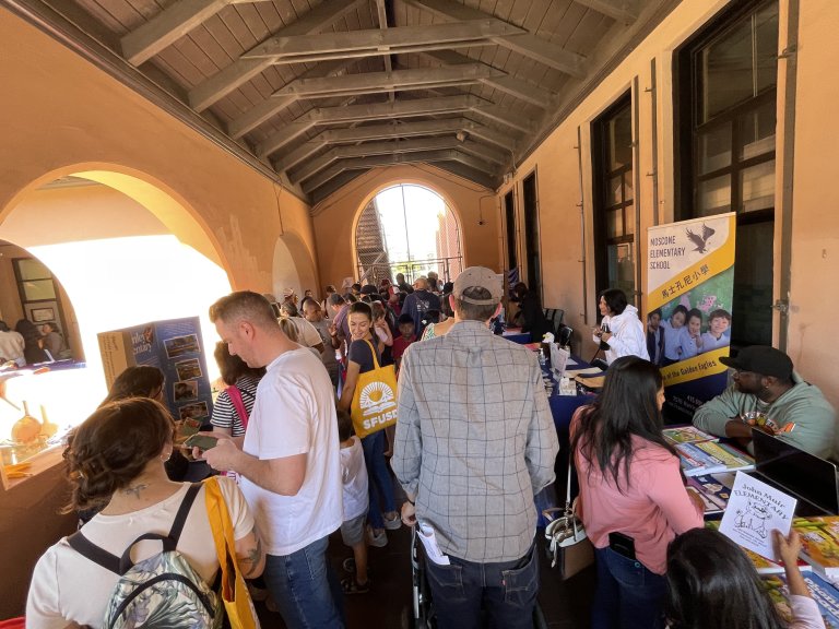 Enrollment Fair walkway filled with parents. 