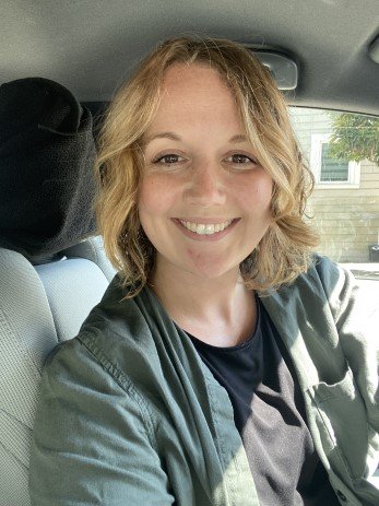 Ms. Liz Watson Speech Language Pathologist in a car wearing a green jacket