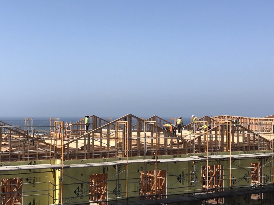 Construction of Shirley Chisholm Village with Pacific Ocean and sky in the background