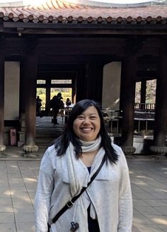 Jessie Banea standing in front of a pagoda