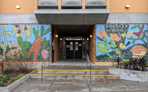 Main entrance to Grattan Elementary School with stairs, a wheelchair ramp, and a mosaic with flowers and animals