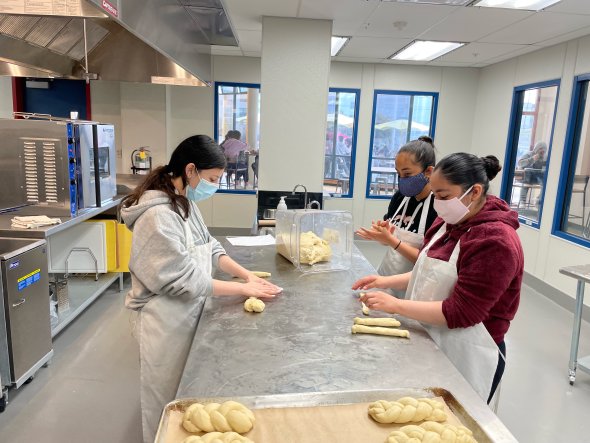 Students baking bread during a job shadow. 