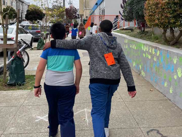Two students walking a loop in the school Walkathon.