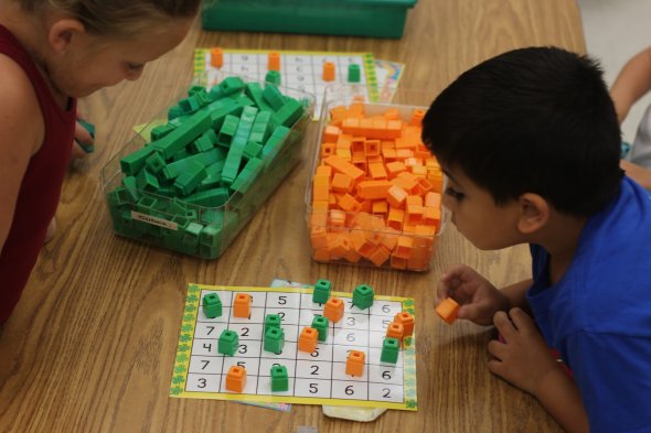 Two kindergarten students playing a number identification game