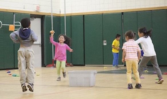 Five kindergarten students playing in gym
