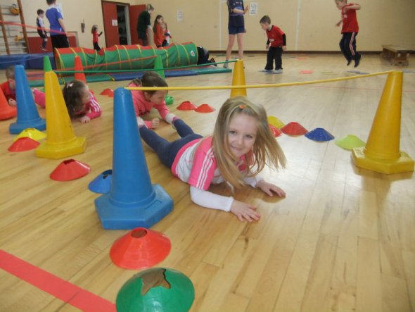 Kindergarten students navigating obstacle course